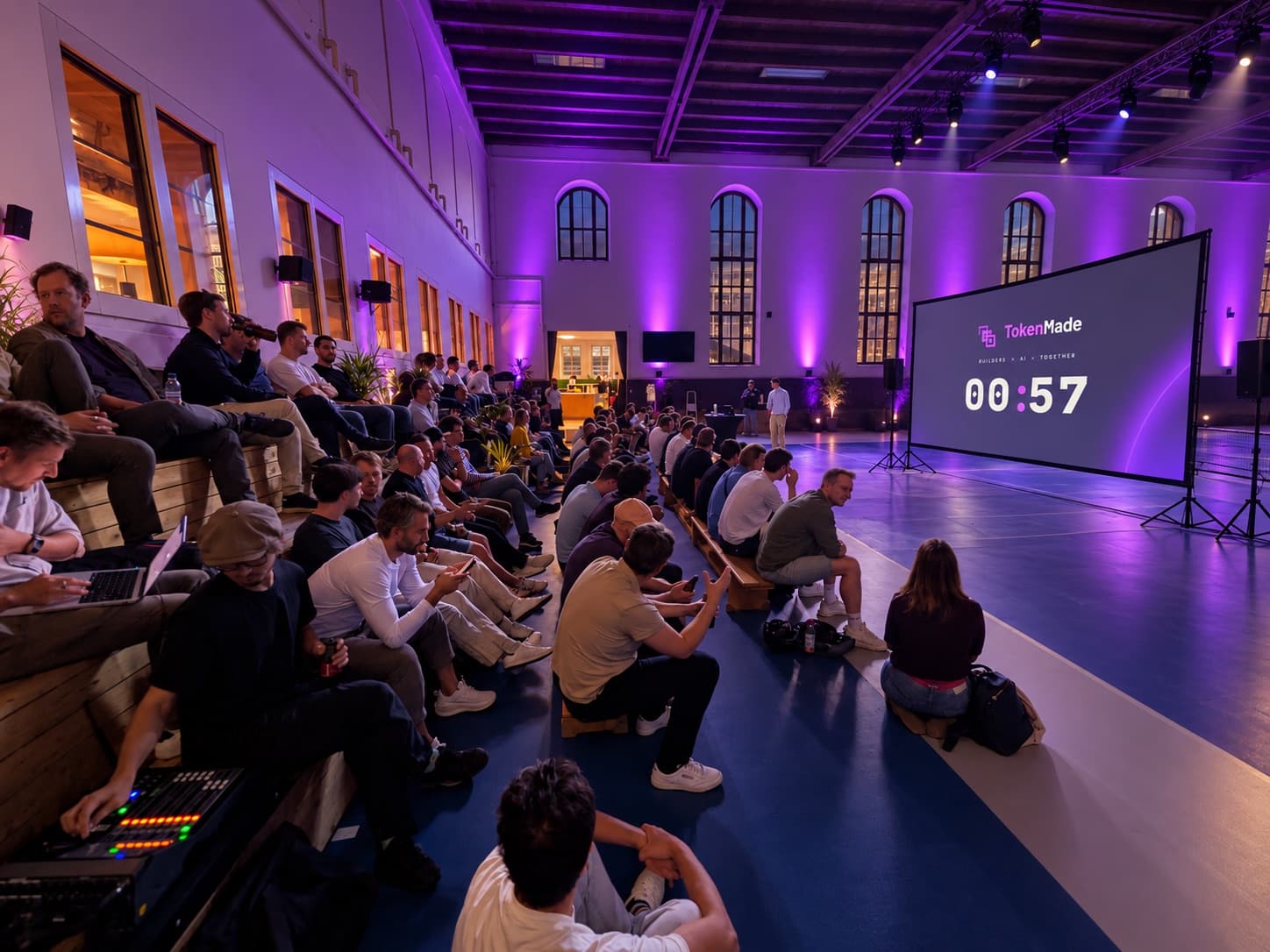 The full room at TokenMade /02 in Munich in purple stage light, the countdown on screen one minute before the start